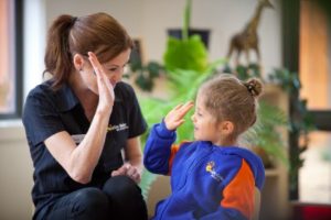 An educator high-fiving a child